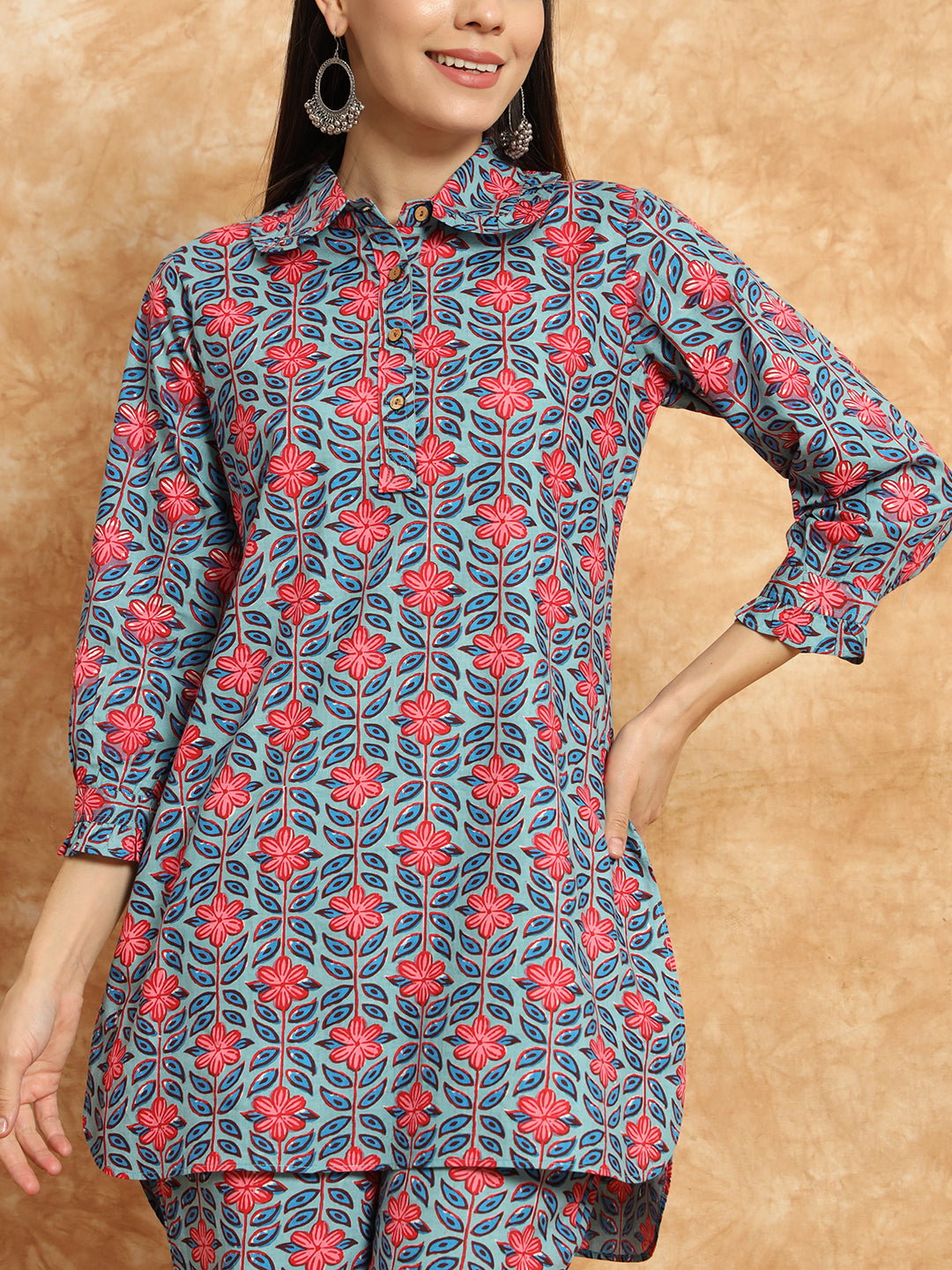 Woman wearing blue and pink floral printed maternity kurta with collar and three-quarter sleeves