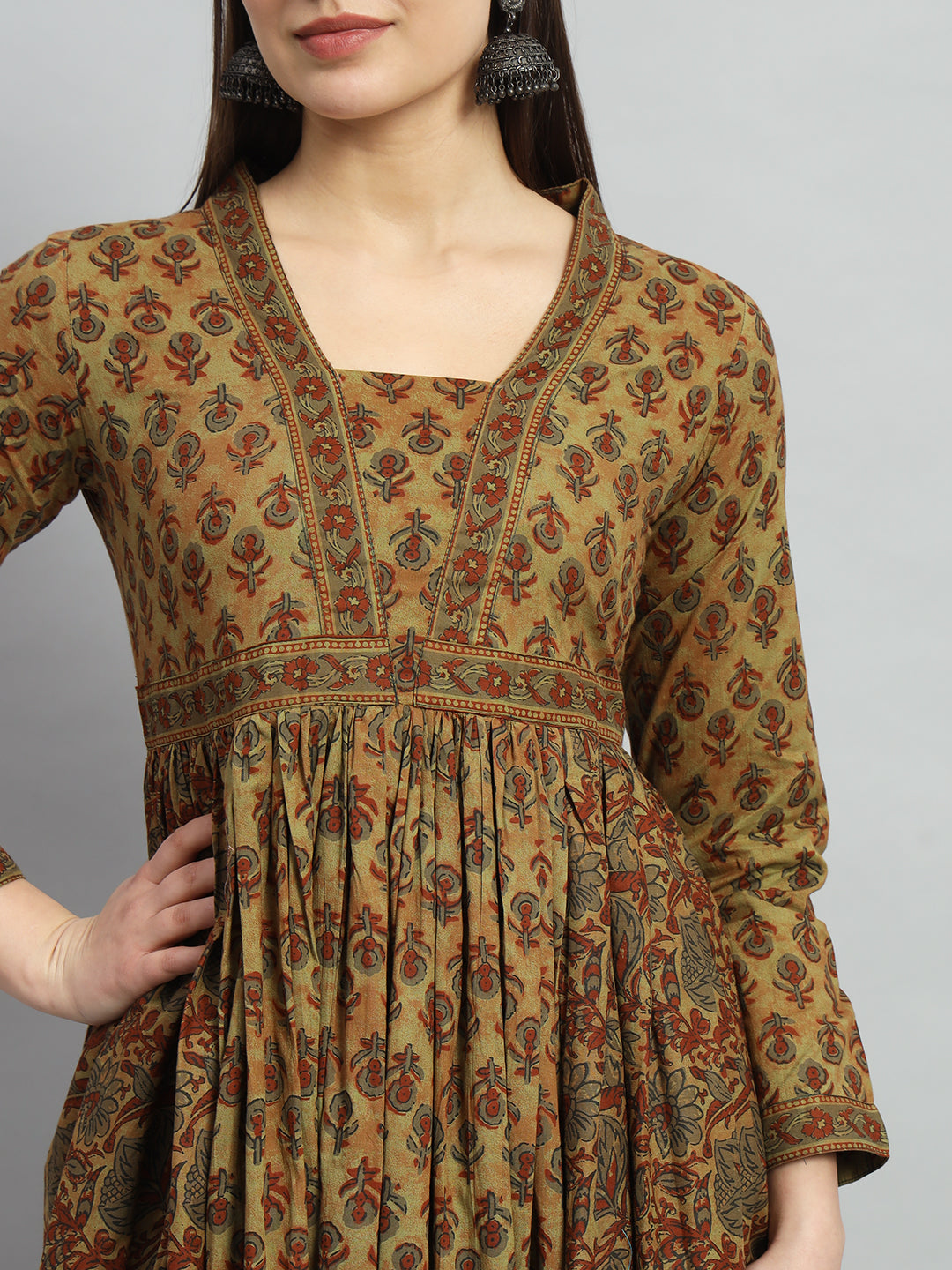 Woman wearing brown floral print maternity kurta with pleated front and long sleeves