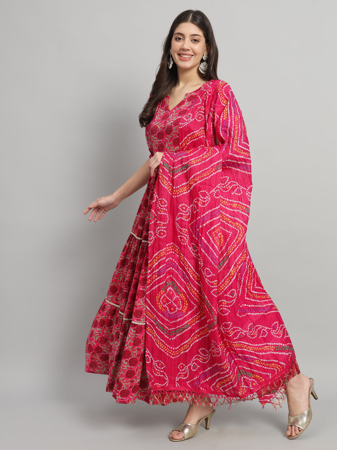Woman wearing a vibrant pink bandhani print maternity maxi dress with dupatta