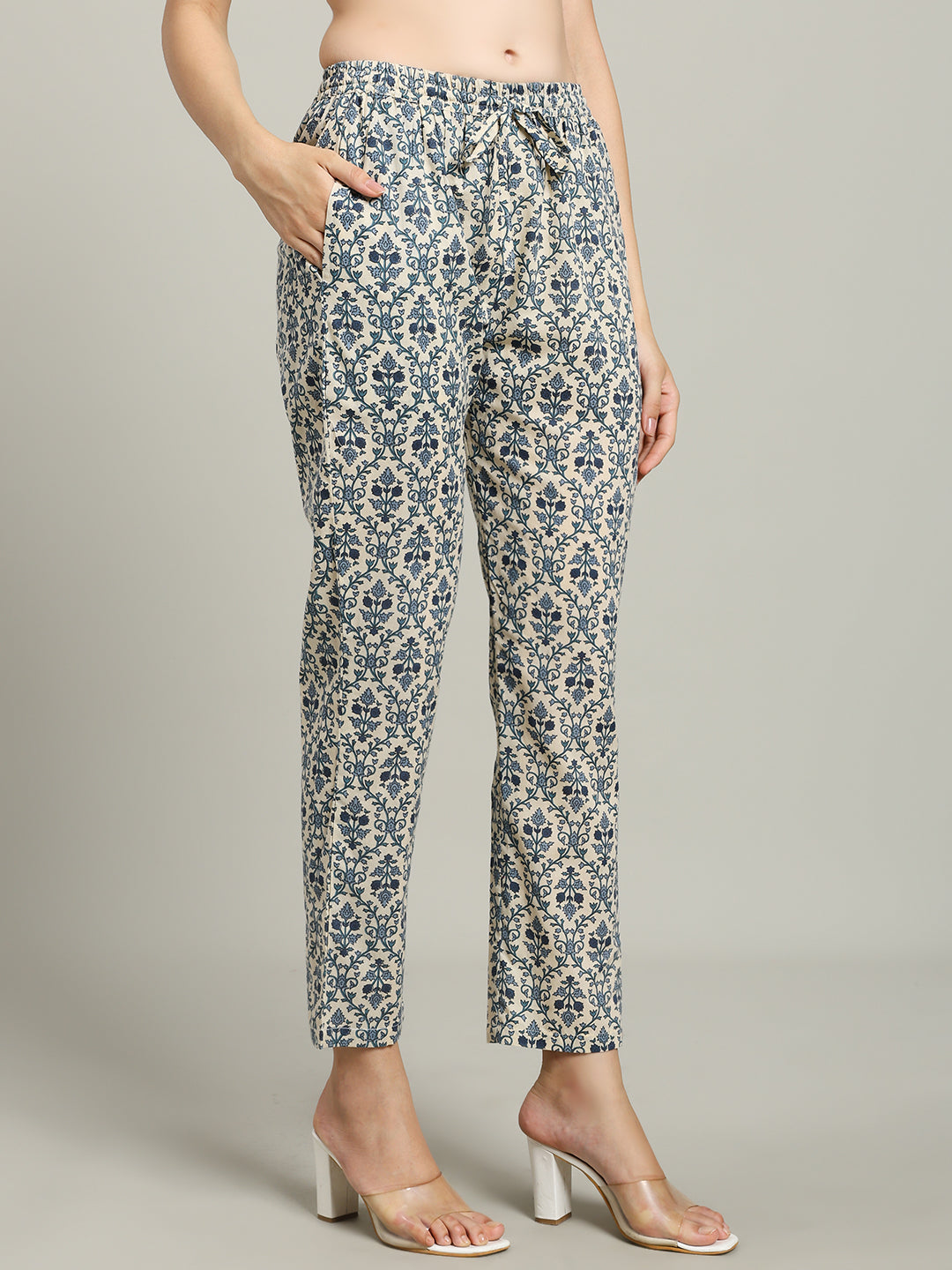Woman wearing blue floral print cotton maternity pants with pockets and drawstring waist