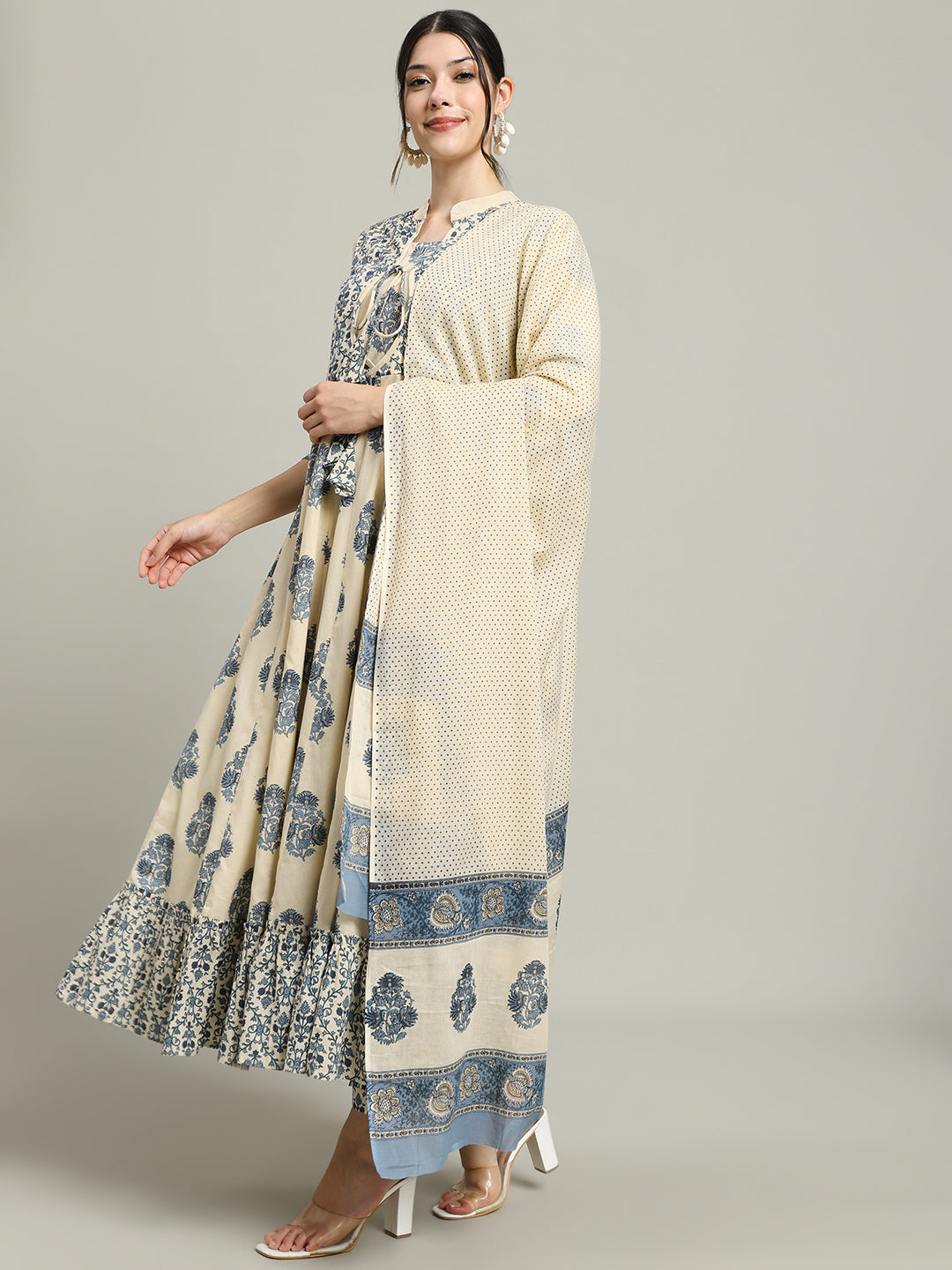 Woman in cream and blue floral maternity maxi dress with dupatta, standing indoors