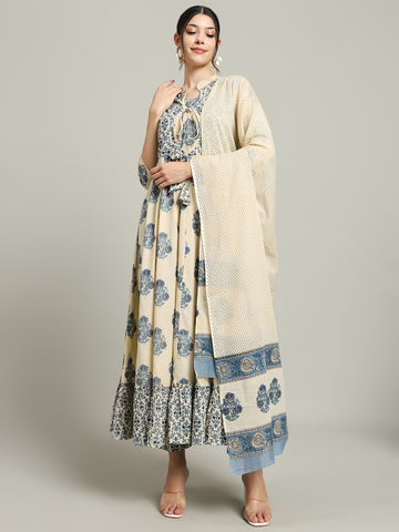 Woman wearing cream and blue floral maternity dress with dupatta, standing against plain background