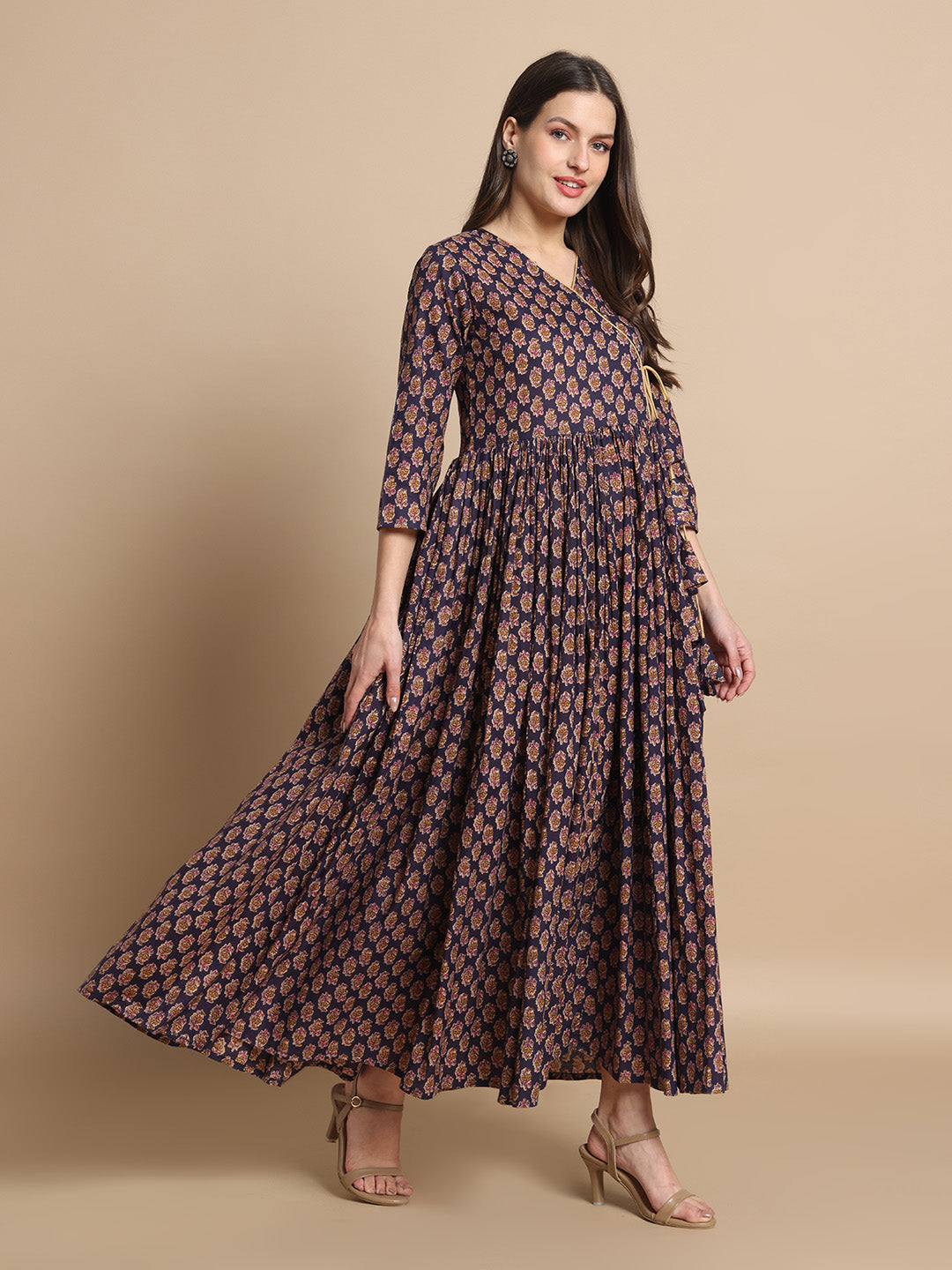 Woman wearing a navy blue floral printed maternity maxi dress with three-quarter sleeves