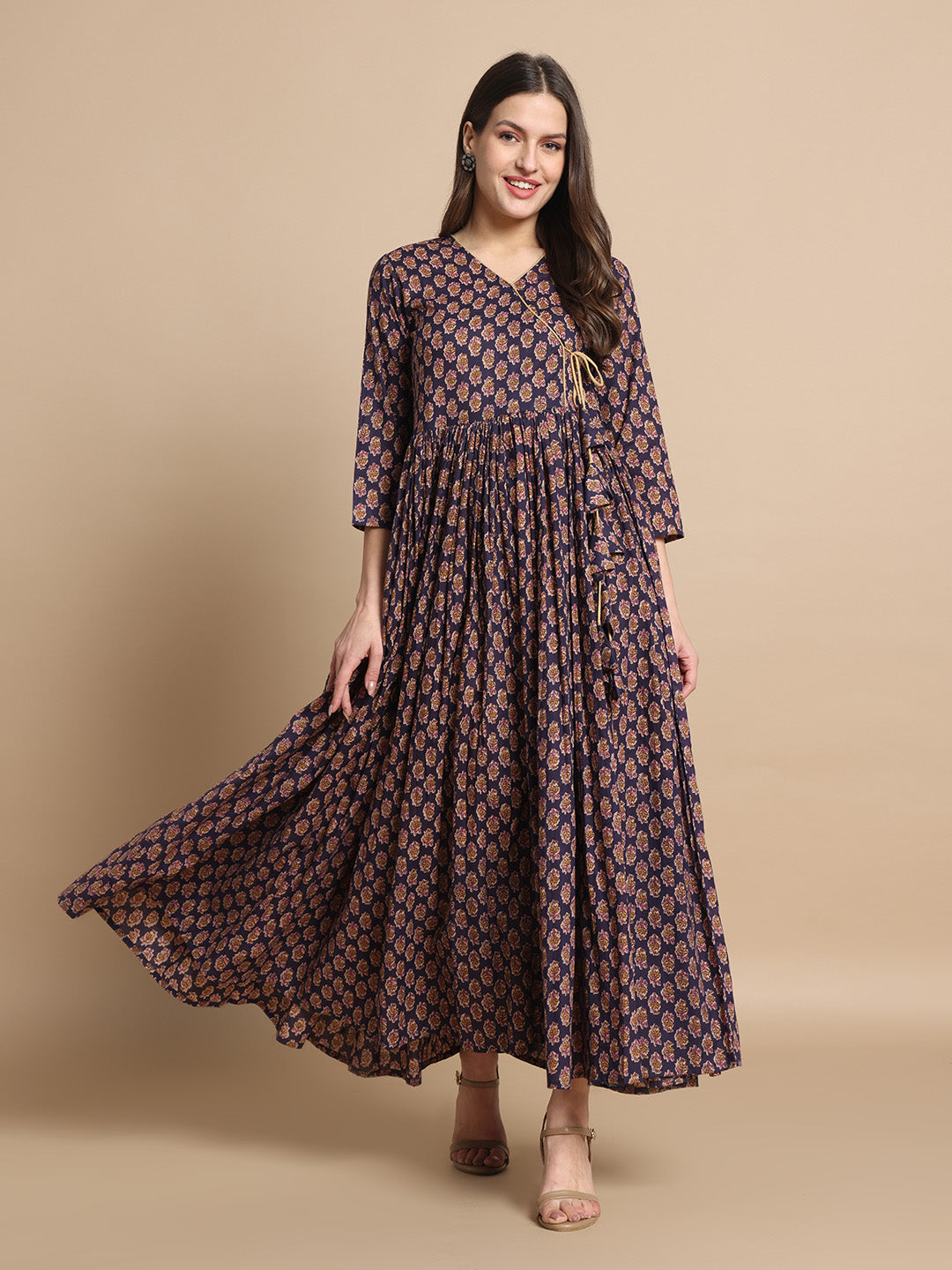 Woman in a navy floral printed maternity maxi dress with three-quarter sleeves
