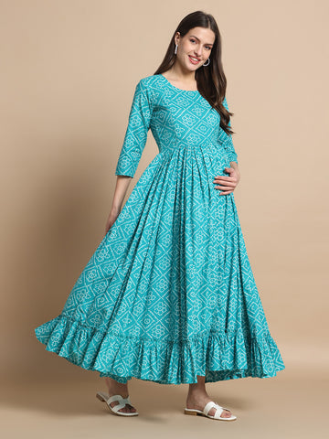 Pregnant woman in teal printed maternity maxi dress with three-quarter sleeves and ruffled hem