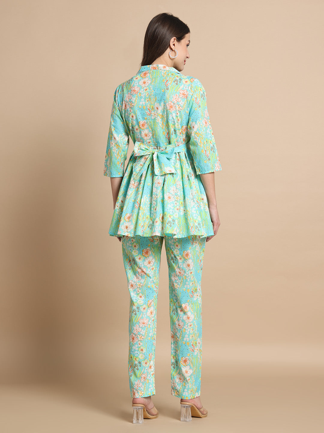 Woman wearing aqua floral maternity kurta set with back tie design, side view