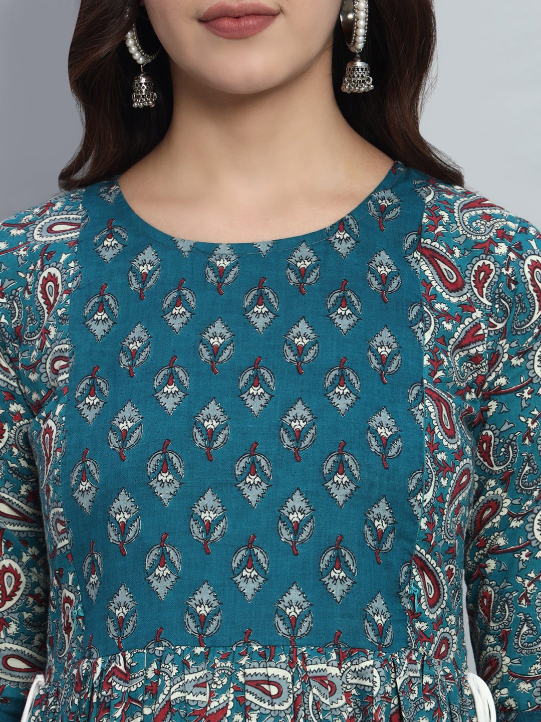 Woman wearing blue floral maternity kurta with ethnic print, round neckline, jhumka earrings