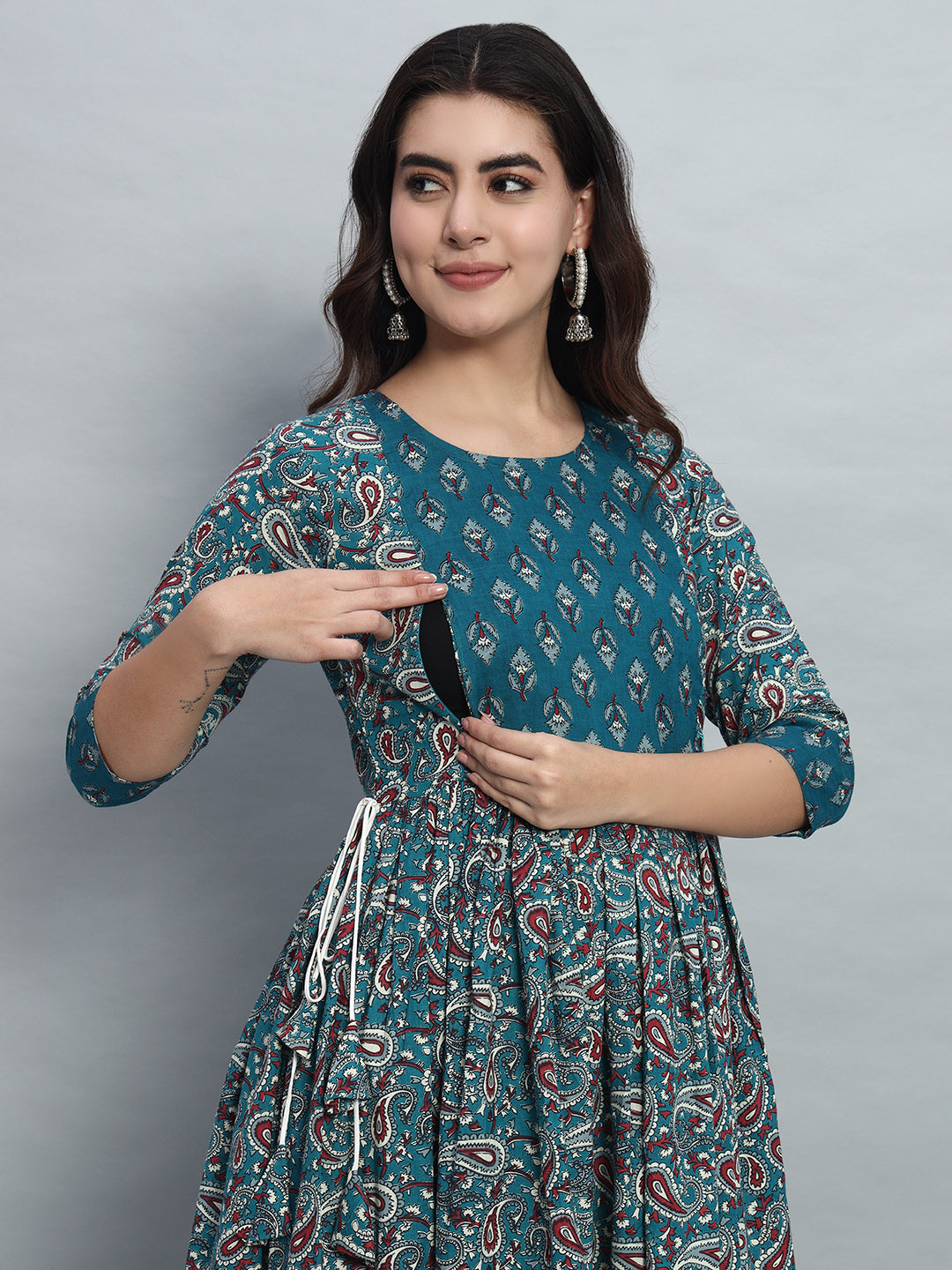 Woman wearing blue printed maternity and nursing dress with front zipper opening