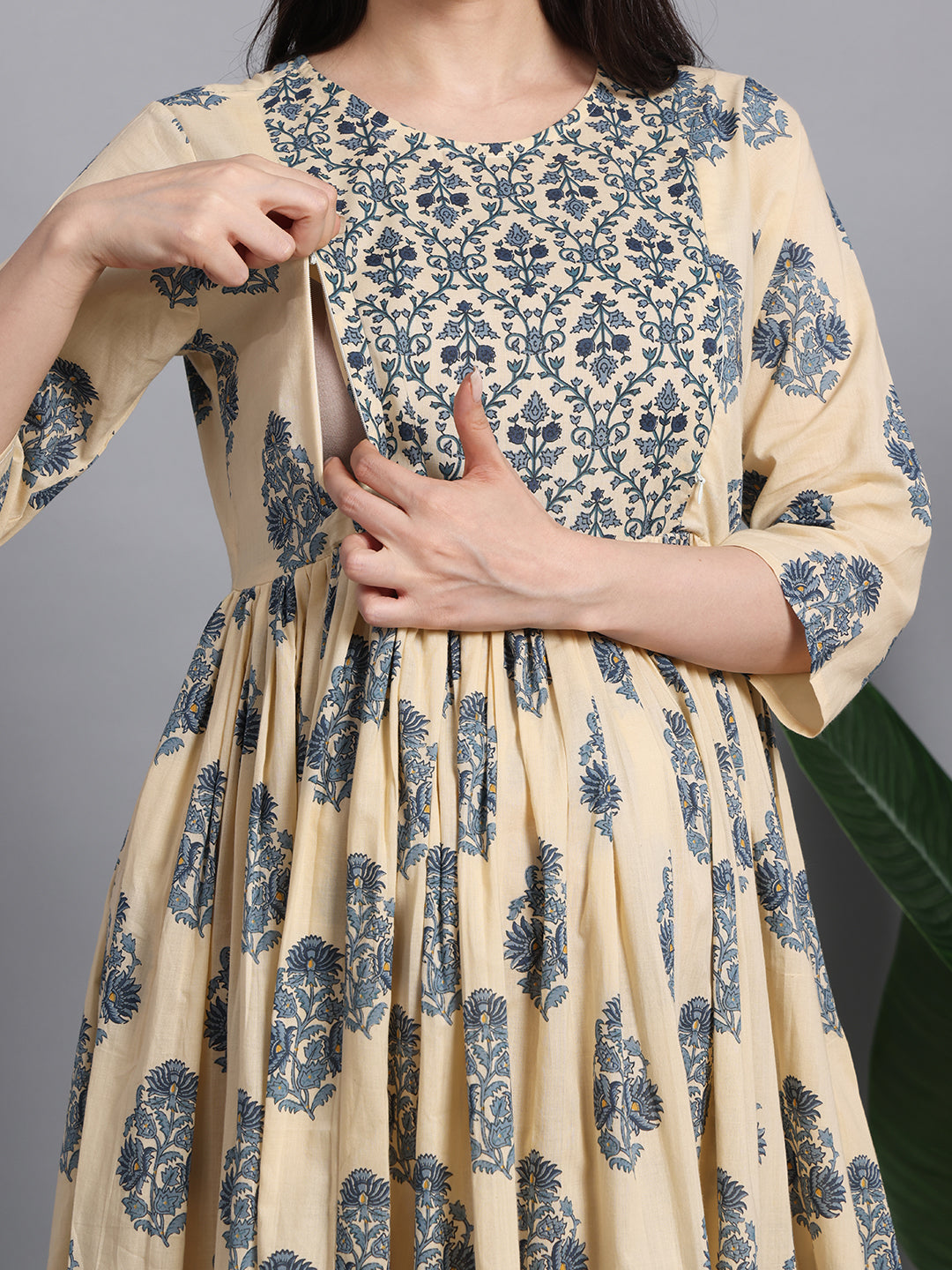 Woman in floral cotton maternity and nursing dress with side zipper for feeding access