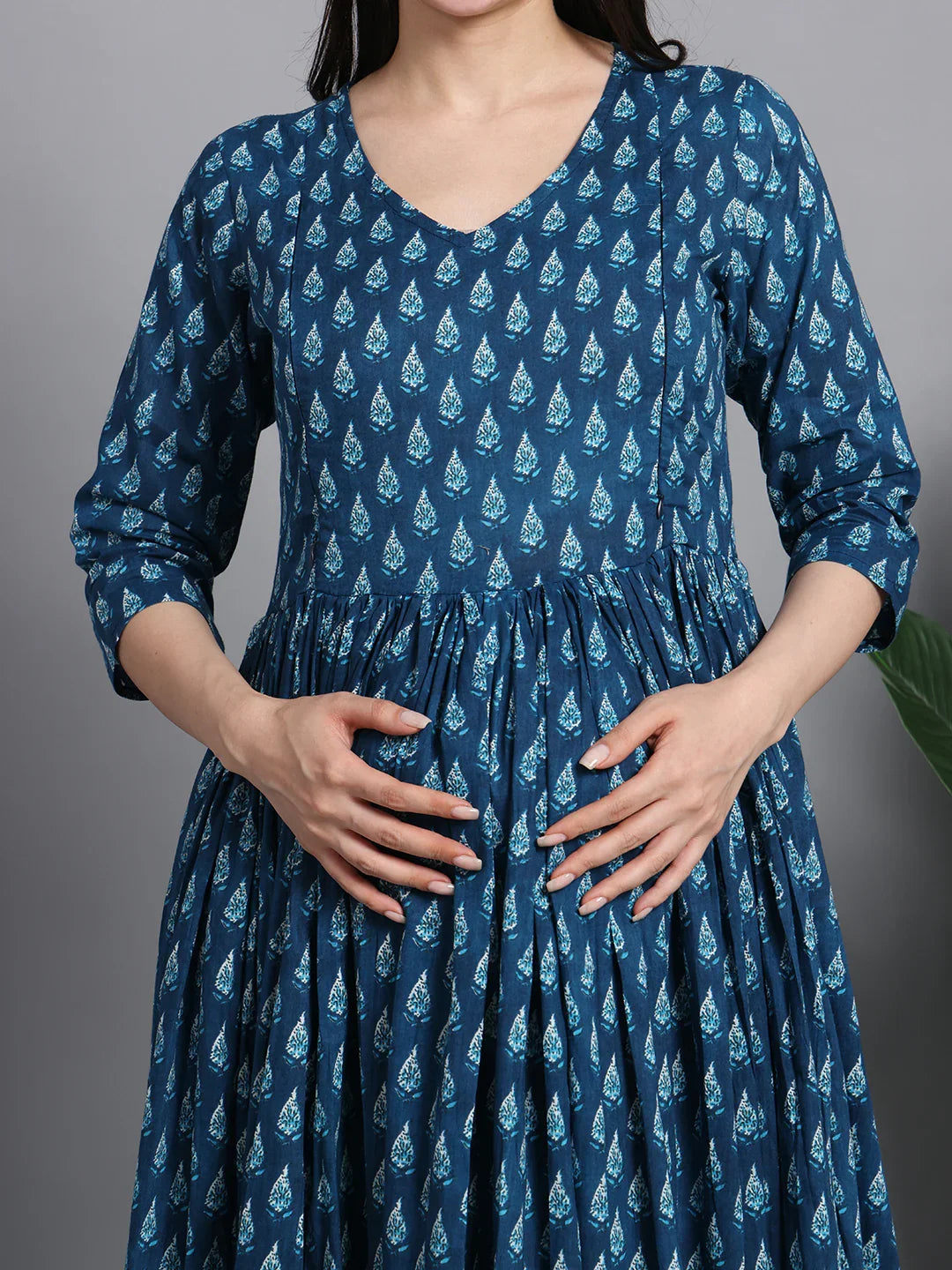 Pregnant woman in blue printed maternity dress with V-neck and three-quarter sleeves