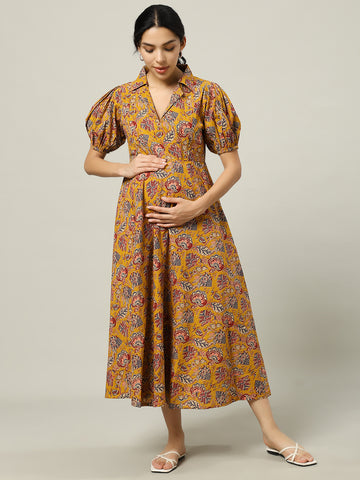 Pregnant woman in yellow floral print maternity dress with puff sleeves and collar