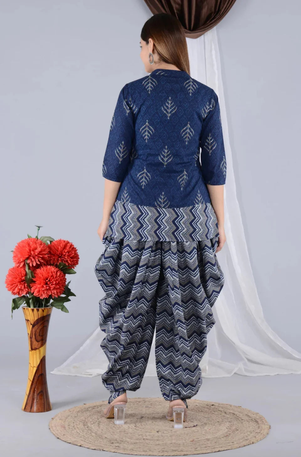 Woman in blue printed maternity kurta with zigzag pattern dhoti pants, standing indoors