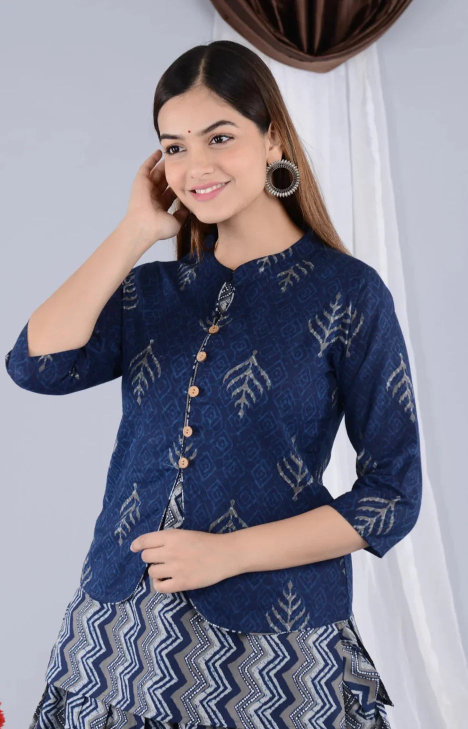Woman in a blue printed maternity kurta with wooden buttons and chevron pattern skirt